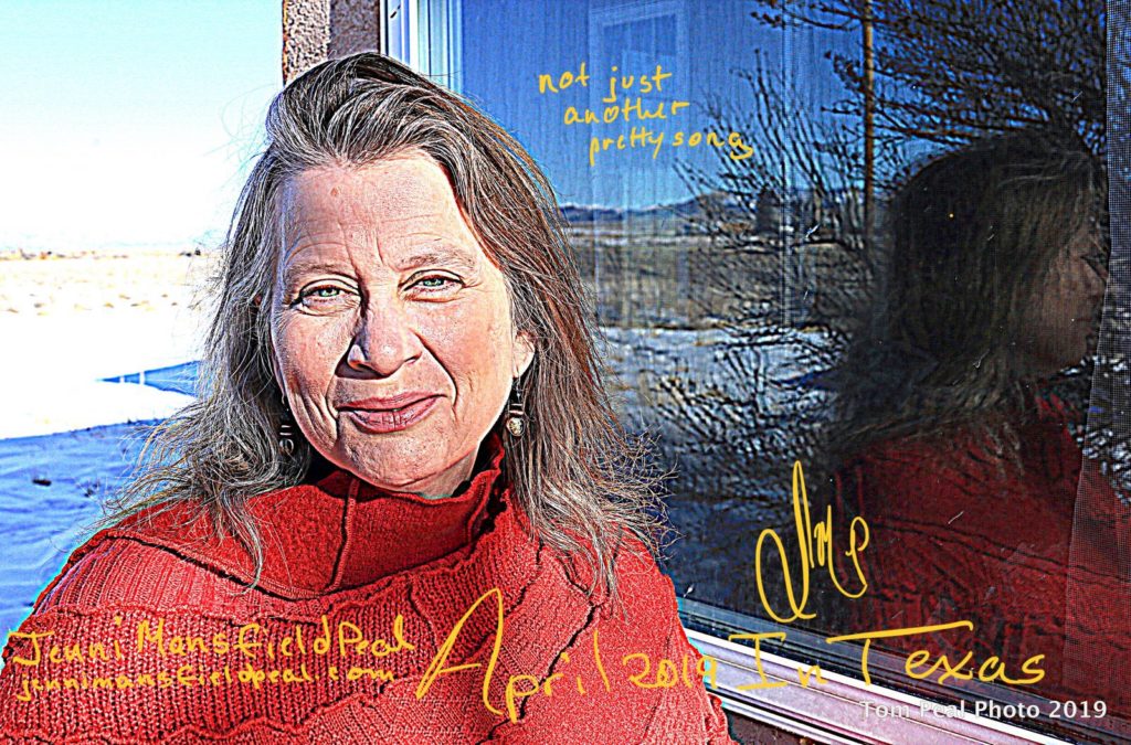 Outdoor photo of Jenni with snow in the background and a window reflecting her.